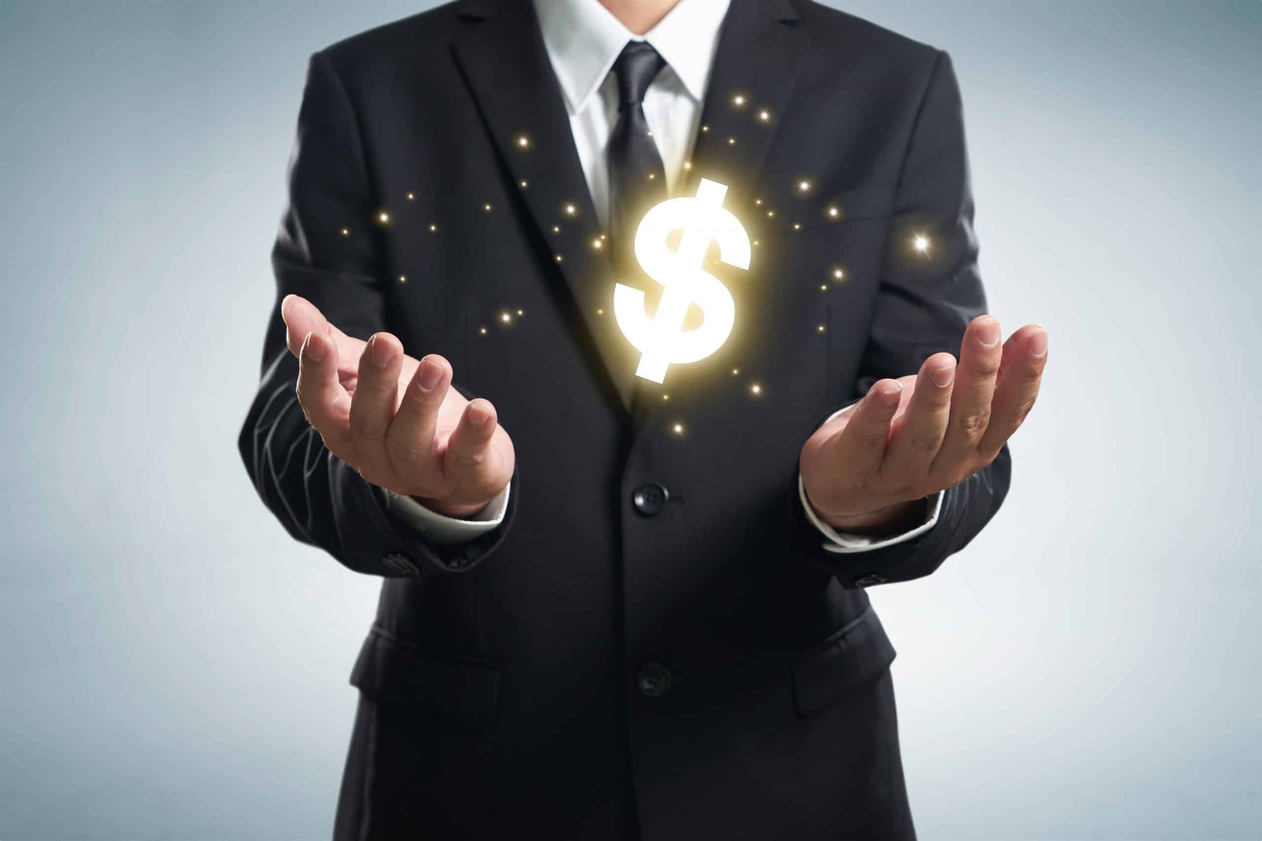 Businessman holding dollar symbol.